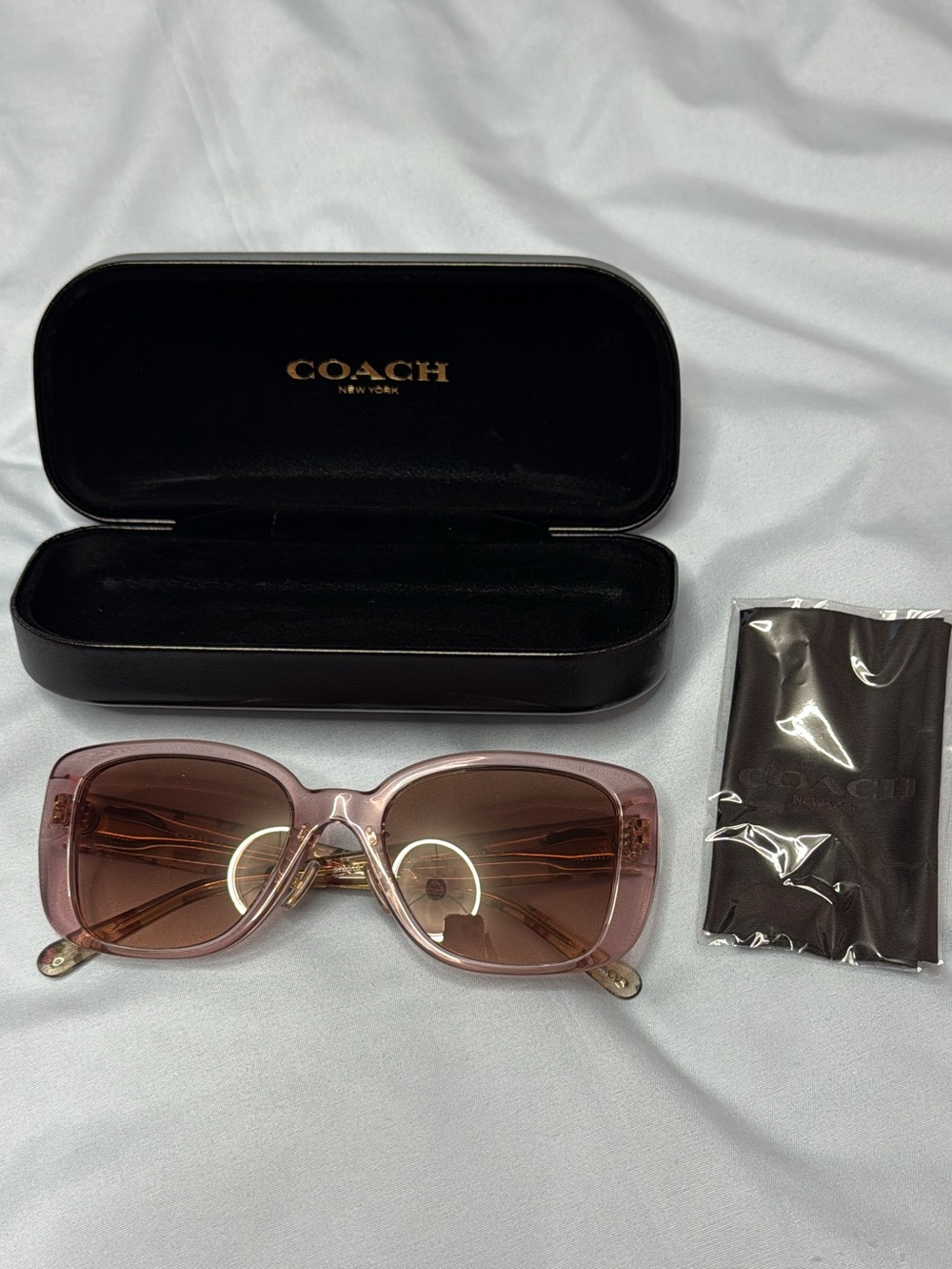 Coach Authentic HC8352 sunglasses with a transparent rose frame and floral print
